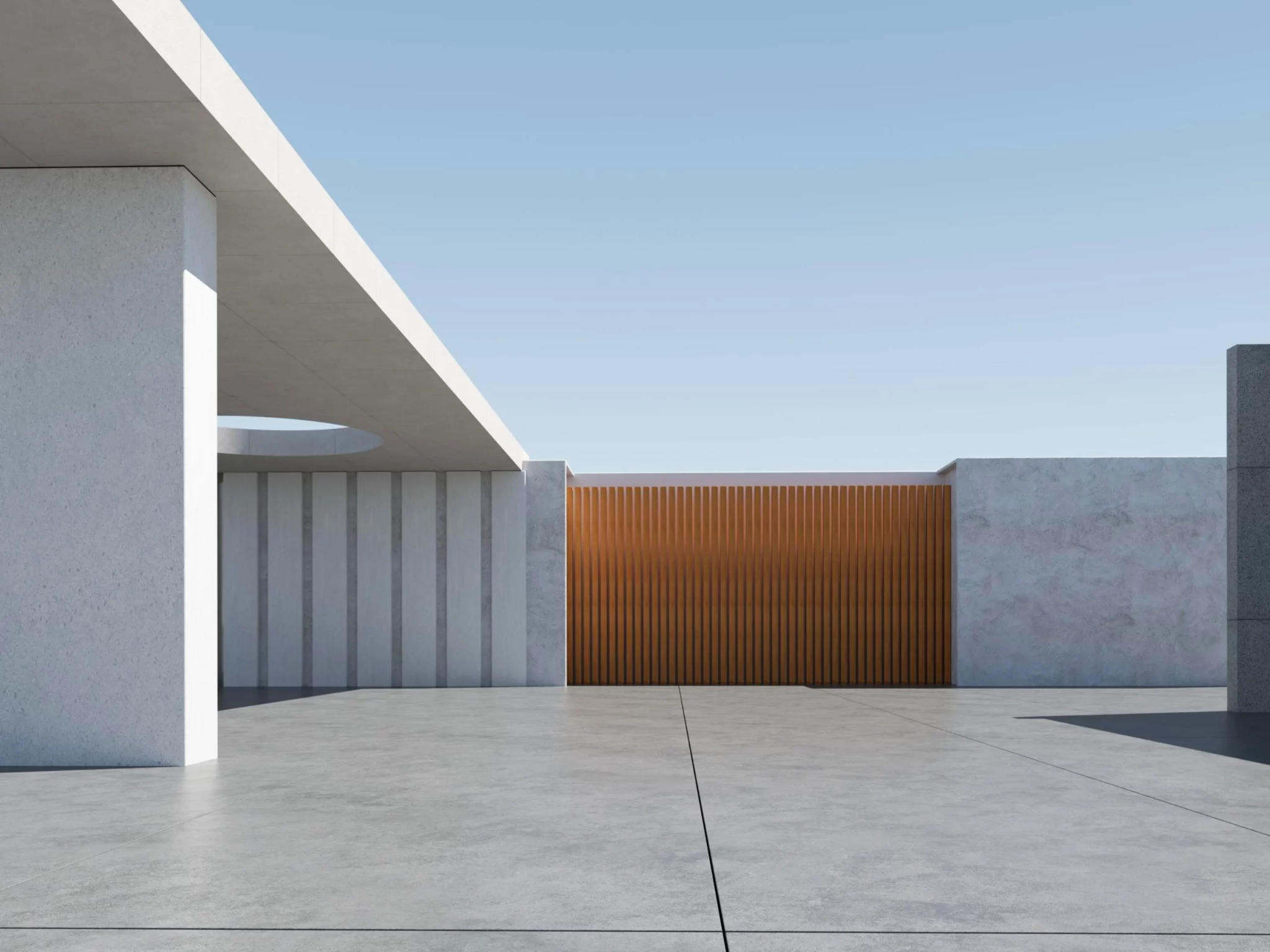 minimalist modern courtyard with concrete walls, a wooden slatted screen in the center, a circular roof cutout, and sharp sunlight under a clear blue sky.